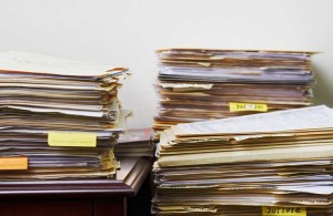 piles of paperwork in manila folders