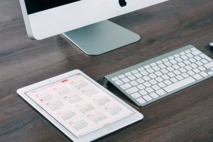 tablet calendar on desk with keyboard monitor